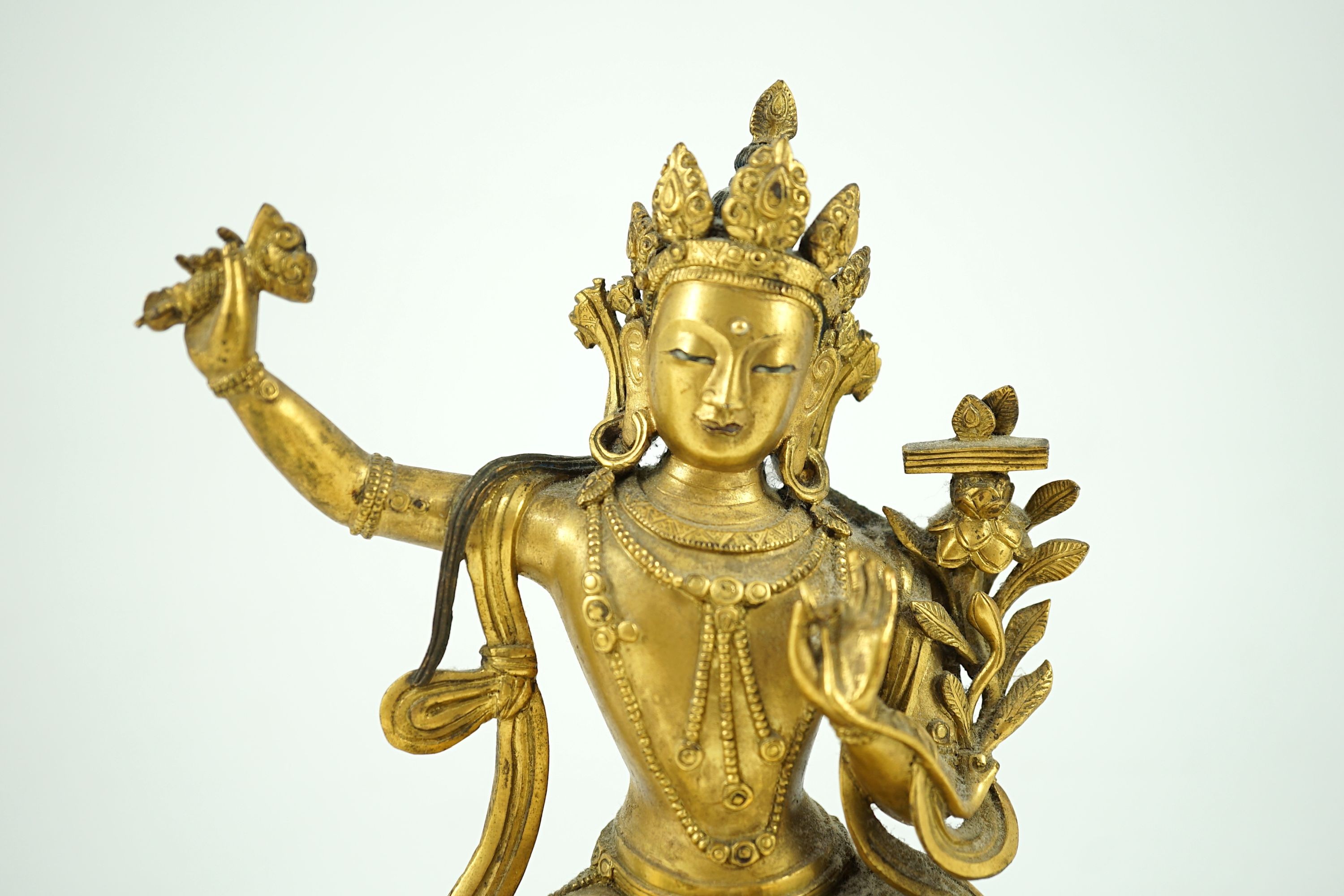 A Tibetan gilt bronze seated figure of Vajrasattva, 16.5 cm high